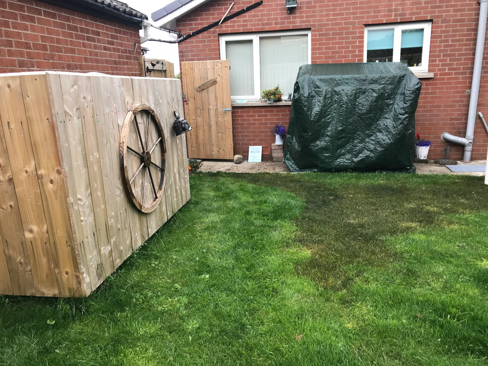 A modern house in the UK or Ireland with a garden, representing a property at risk from a domestic oil spill